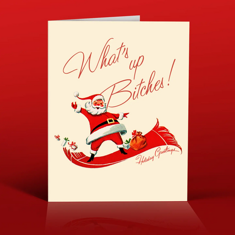 Vintage-style Santa holiday card with hand-lettered text 'What's Up Bitches!'. Santa is smiling in his sleigh.