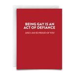 BEING GAY IS AN ACT OF DEFIANCE GREETING CARD from Virgins On Fire Candle Co. Red card. White font.