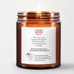 Candle in a glass jar with a label on a white background. It has the company details like this candle was handmade by a gay man, not a multinational corporation with a rainbow logo 30 days out of the year. and that it's 9oz, and has a 45-50 hour burn time.