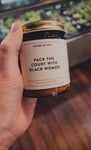 lifetyle photo. someone is holding the pack the court with black women candle.
