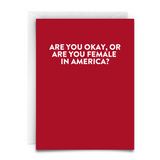 a greeting card with large font and red background. white envelope. the text says, Are you okay, or are you female in america?