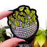 DISCO BALL PLANTER STICKER. Glittery disco ball. Plant inside of it. Cartoon style. Hand drawn. This photo is the sticker being held by the maker in their fingers. Black bail polish.