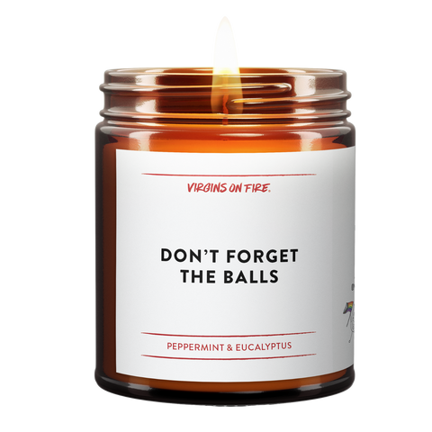 Amber glass candle jar from Virgins On Fire Candle Co., a gay-owned Brooklyn business. Label reads, "Don't Forget the balls." It is a peppermint & eucalyptus scented candle. 
