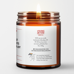 the back of a burning candle. glass amber jar. this says 9oz jar, 45-50 hours burn time. and that this candle is handmade by a gay man, not a multinational corporation with a rainbow logo 30 days out of the year.