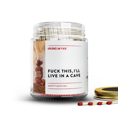 Clear glass jar filled with red tipped safety matches, featuring a minimalist label reading, "Fuck This, I'll Live in a cave." features a photo of a contemplative modern woman in a cave.