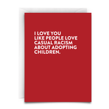 A red card, with white text, and a white envelope. The card reads, " I LOVE you like people love casual racism about adopting children"