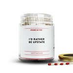 Clear glass jar filled with red tipped safety matches, featuring a minimalist label reading 'I'd rather be upstate."