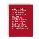Red greeting card with white text offering support and hope to those facing discrimination. Message acknowledges adversity while affirming that accepting, loving people exist and can be found
