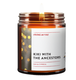 a burning brown jar candle called kiki with the ancestors. it's gin and cypress. party light photo on the label, too.