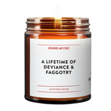 Candle in a glass jar with a label on a white background. the candle is called A Lifetime of Deviance and Faggotry. It is Leather and Rose Scented.
