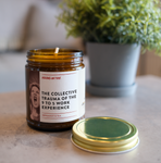 collective trauma of the 9-5 work experience candle in a living room.