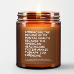 a lit candle called, "Embracing the decline of my mental health because the american healthcare system makes therapy too expensive."