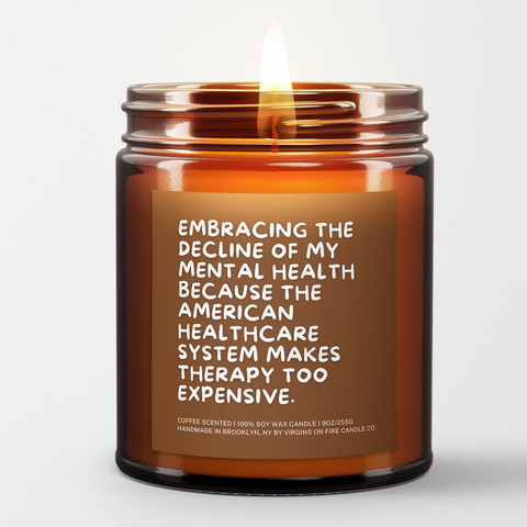 a lit candle called, "Embracing the decline of my mental health because the american healthcare system makes therapy too expensive."