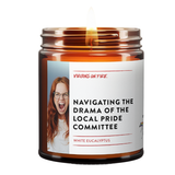 a burning brown amber candle that is called Navigating the Drama of the local pride committee. it shows a woman screaming in frustration.