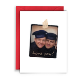 A greeting card -- two navy boys smiling. the card says Love You. Red Envelope.