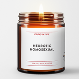 a burning candle. it is a brown amber jar. white label. black font. it says Neurotic Homosexual. red virgins on fire logo. red font that reads Sea Salt and Eucalyptus.