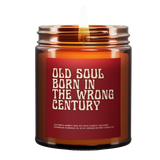 a lit amber candle with the name "Old Soul Born in the wrong century." Old font. Red background. White font.