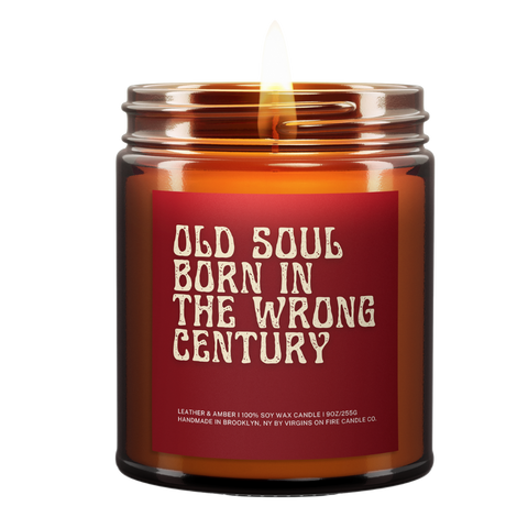 a lit amber candle with the name "Old Soul Born in the wrong century." Old font. Red background. White font.