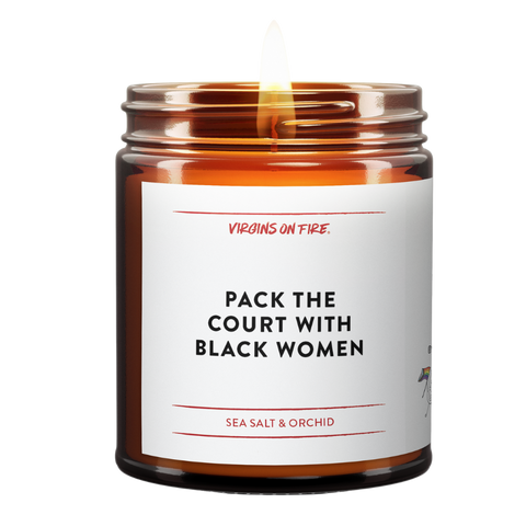 this candle is named "pack the court with black women". simple minimalist label. brown amber jar. lit. sea salt and orchid scented.