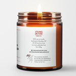 Back label of amber glass candle jar showing product details for Virgins On Fire Candle Co, a funny candle, gay-owned small business in Brooklyn, NY. 100% soy wax, handmade in Brooklyn, 45-50 hour burn time, non-toxic, 9oz size. Features Virgins on Fire Candle Co. branding, contact information, and cartoon flame mascot with rainbow flag. Includes a note about being handmade by a gay man rather than a corporation with a rainbow logo 30 days out of the year."