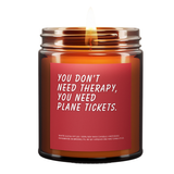 Candle jar with a red label and humorous text on a white background