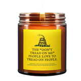 a burning candle with a label based on the Gadsen flag. Yellow background. Black and white snake. Green grass.