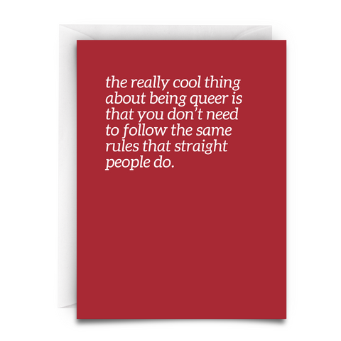 A greeting card - red - white white font - and white envelope that says - the really cool thing about being queer is that you don't need to follow the same rules that straight people do.
