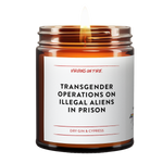 brown amber candle with label, "transgender operations on illegal aliens in prison." it's a dry cypress and amber scent.