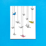 paper cranes hanging from the sky. greeting card. letterpress. various colors.