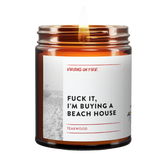 Fuck It, I'm Buying a Beach House is the name of a candle from Virgins On Fire Candle Co. It is Teakwood scented, and available for sale online for $15 at www.virginsonfire.com