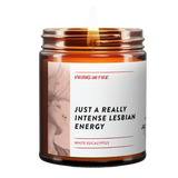 Bestselling 'Just A Really Intense Lesbian Energy' candle with White Eucalyptus fragrance from LGBTQ+-owned Virgins On Fire Candle Co. 9oz soy wax candle in amber glass jar with artistic label design. Handmade in Brooklyn with queer humor and pride. Perfect gift for the LGBTQ+ community and allies