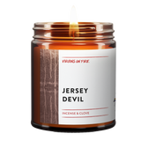 an amber jar candle called, "Jersey Devil" This New Jersey Candle is from Virgins On Fire Candle Co. It is incense and clove scented. It features a creepy photo of a swamp in black and white.