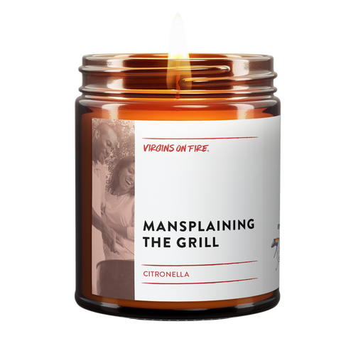 this is a brown amber jar candle with the text, "mansplaining the grill." it is a citronella candle. 