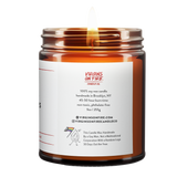 Back label of amber glass candle jar showing product details for Virgins On Fire Candle Co, a funny candle, gay-owned small business in Brooklyn, NY. 100% soy wax, handmade in Brooklyn, 45-50 hour burn time, non-toxic, 9oz size. Features Virgins on Fire Candle Co. branding, contact information, and cartoon flame mascot with rainbow flag. Includes a note about being handmade by a gay man rather than a corporation with a rainbow logo 30 days out of the year."